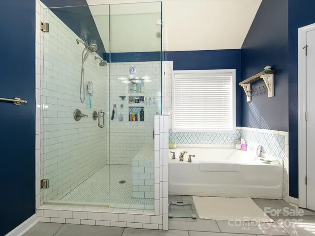 a bathroom with a bathtub and a shower