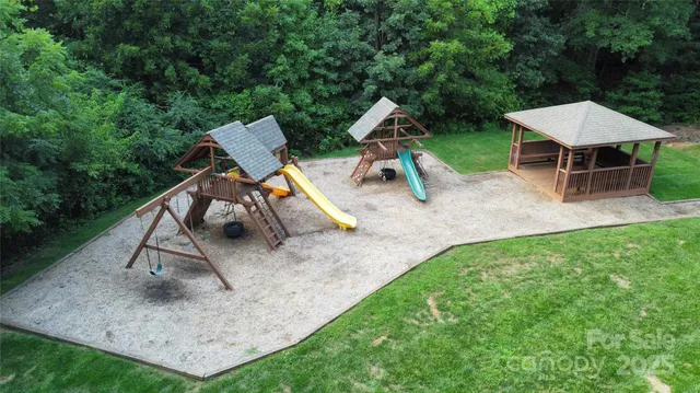 an aerial view of a house with backyard and outdoor seating