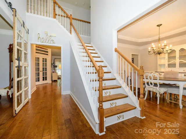 a view of entryway and hall with wooden floor