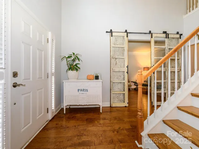 a view of hallway with wooden floor and stairs