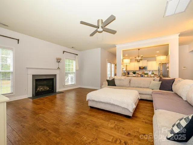 a living room with a bed furniture and a fireplace