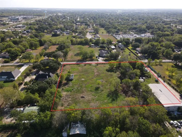 an aerial view of town with residential houses with outdoor space and trees
