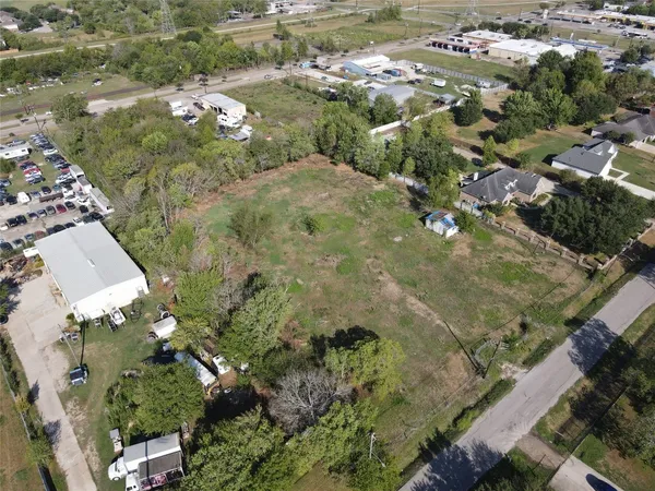 an aerial view of a houses with yard