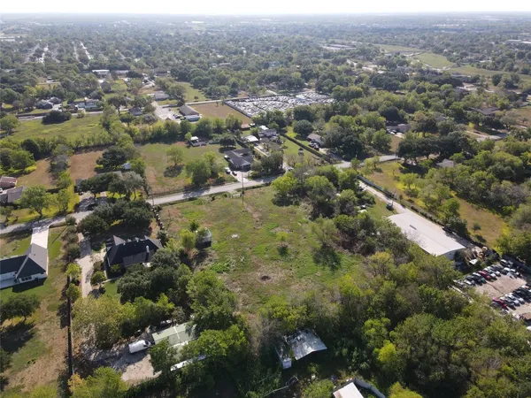 an aerial view of house with yard and mountain view in back