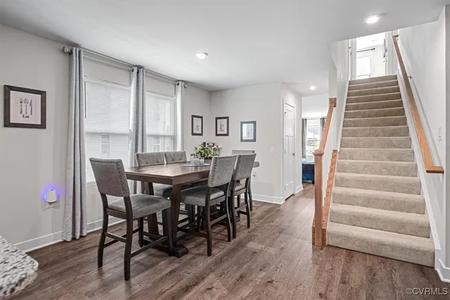 a view of a dining room with furniture and wooden floor