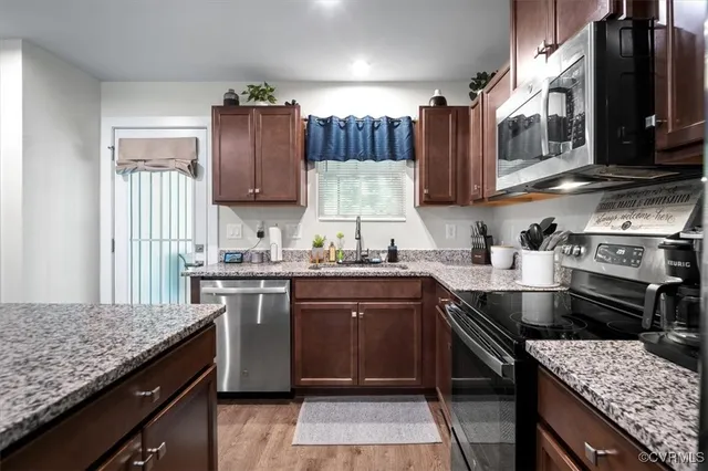 a kitchen with a stove sink and cabinets