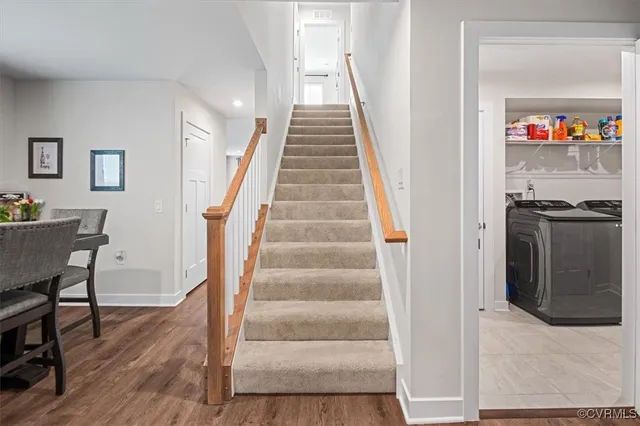 a view of entryway and hall with wooden floor