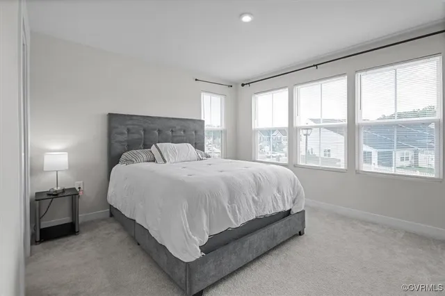 a bed sitting in a bedroom next to a window