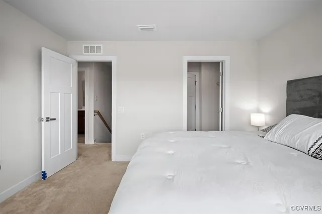 a bedroom with a bed and a lamp