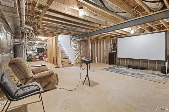 a view of a livingroom with furniture and a black umbrella