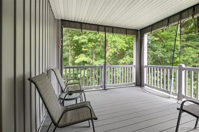 a view of a hallway with chairs and a window