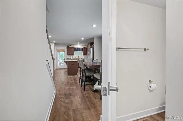 a view of a living room with a table and chairs