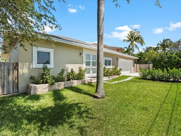 a view of a house with backyard and a garden