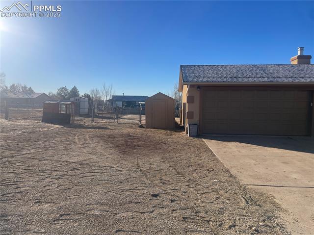35 Diamond E Road Fountain, CO 80817 - Photo 2 of 27 Side yard next to garage offers RV parking option