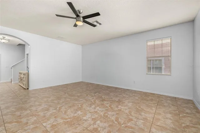 a view of an empty room with window and cabinet