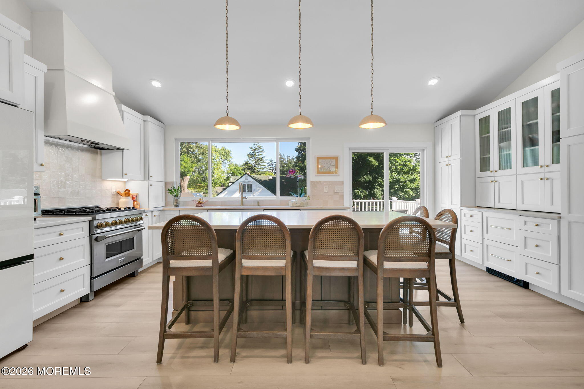 53 Field Avenue Red Bank, NJ 07701 - Photo 3 of 39 a kitchen with stainless steel appliances kitchen island granite countertop a stove a refrigerator a dining table and chairs with wooden floor