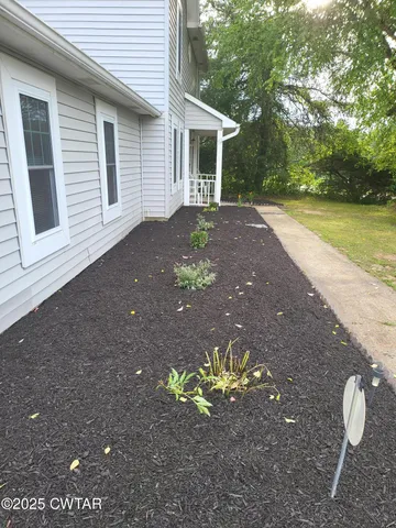 a backyard of a house with table and chairs