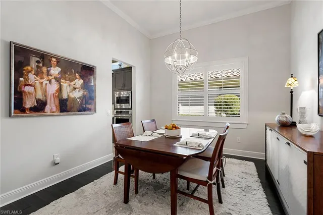 a view of a dining room with furniture wooden floor and a chandelier
