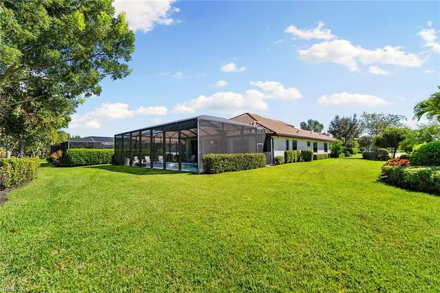 a view of yard with swimming pool and green space