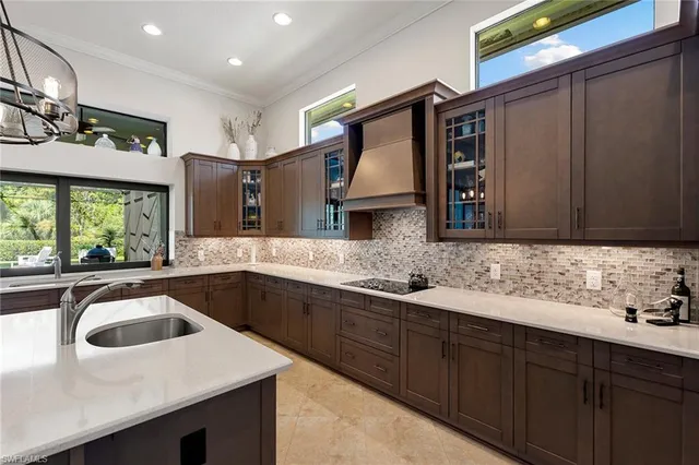 a kitchen with stainless steel appliances a sink stove and cabinets