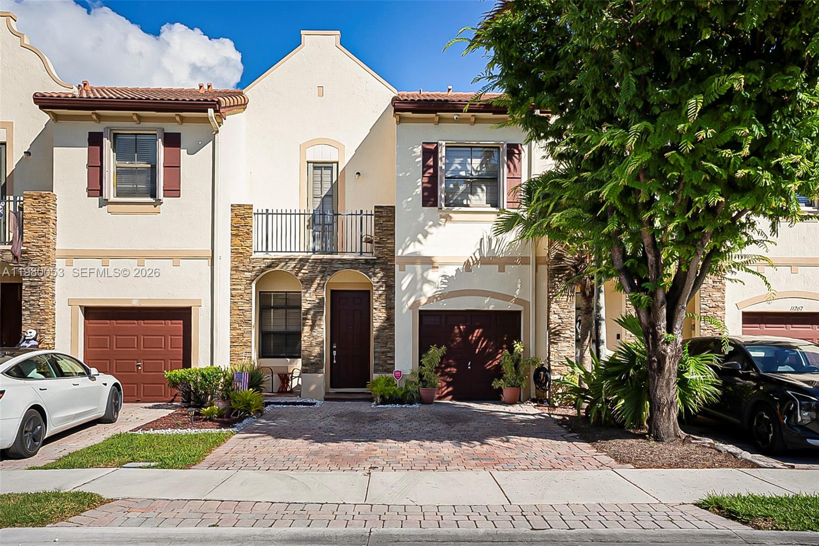 11271 Southwest 234 Terrace Homestead, FL 33032 - Photo 1 of 44 a front view of a house with a yard and garage