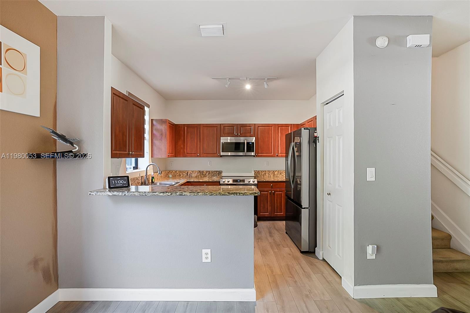 11271 Southwest 234 Terrace Homestead, FL 33032 - Photo 13 of 44 a open kitchen with stainless steel appliances granite countertop a refrigerator and a sink