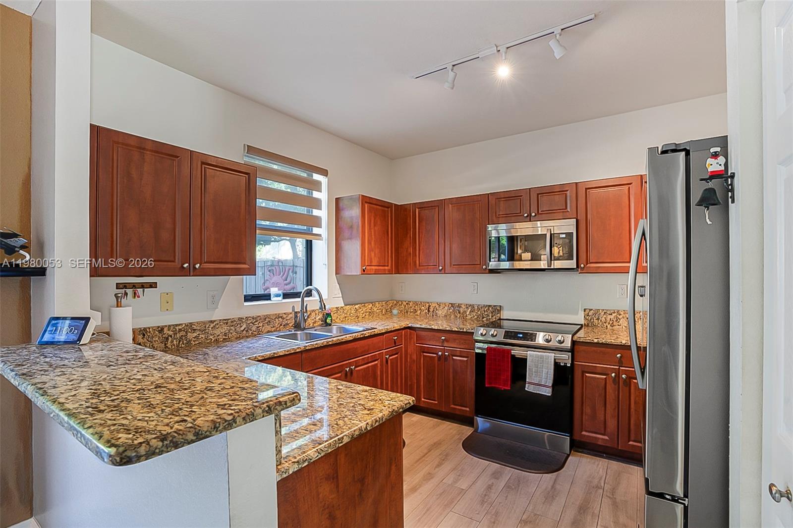 11271 Southwest 234 Terrace Homestead, FL 33032 - Photo 14 of 44 a kitchen with stainless steel appliances granite countertop a sink stove and cabinets