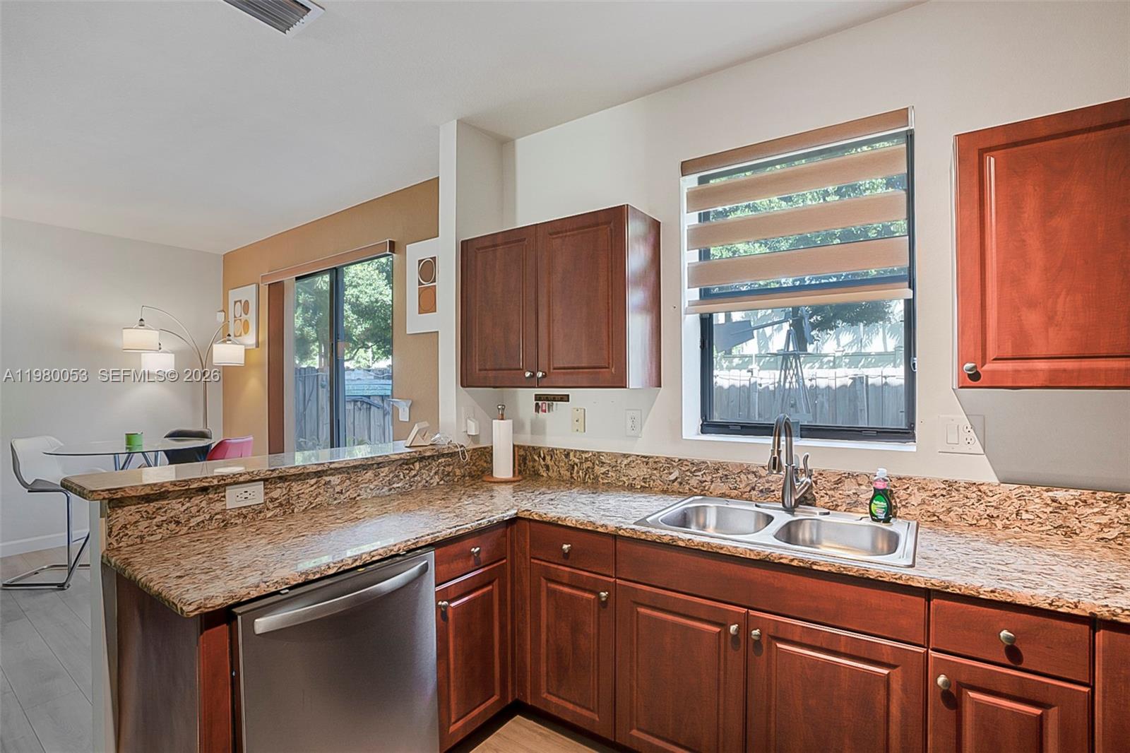 11271 Southwest 234 Terrace Homestead, FL 33032 - Photo 15 of 44 a kitchen with granite countertop cabinets sink and window