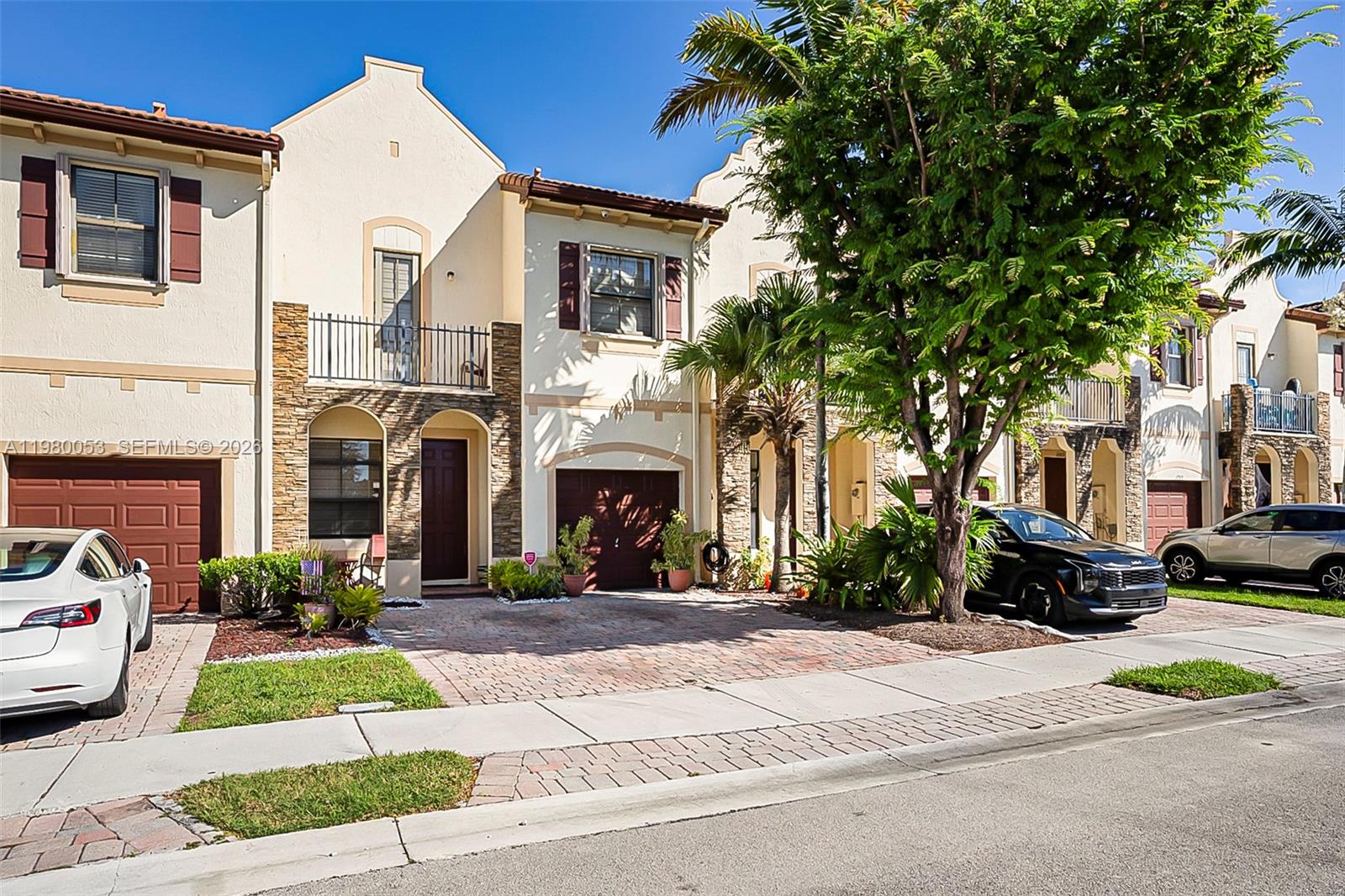 11271 Southwest 234 Terrace Homestead, FL 33032 - Photo 2 of 44 a front view of a house with a yard and garage