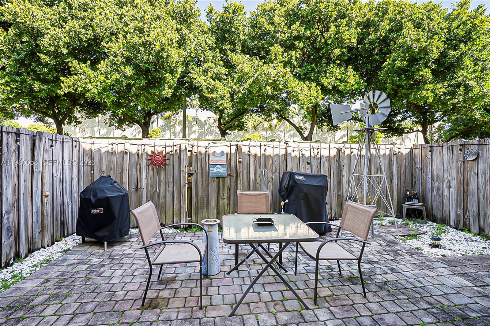 11271 Southwest 234 Terrace Homestead, FL 33032 - Photo 30 of 44 a view of a chairs and table in backyard
