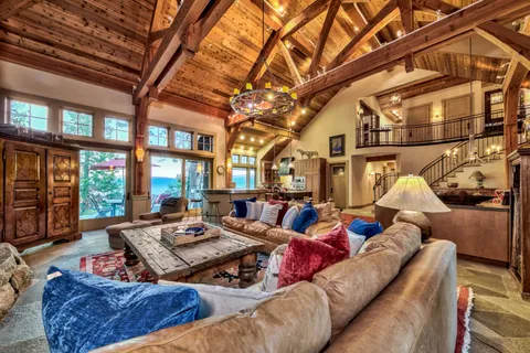 a living room with furniture and a floor to ceiling window
