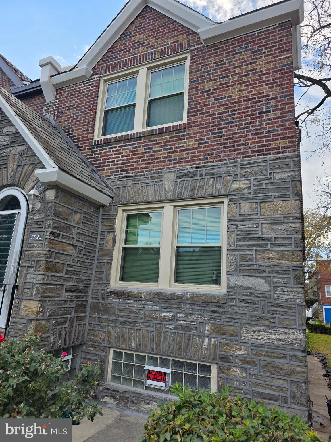 7522 North 21st Street Philadelphia, PA 19138 - Photo 23 of 26 a brick house with a small yard