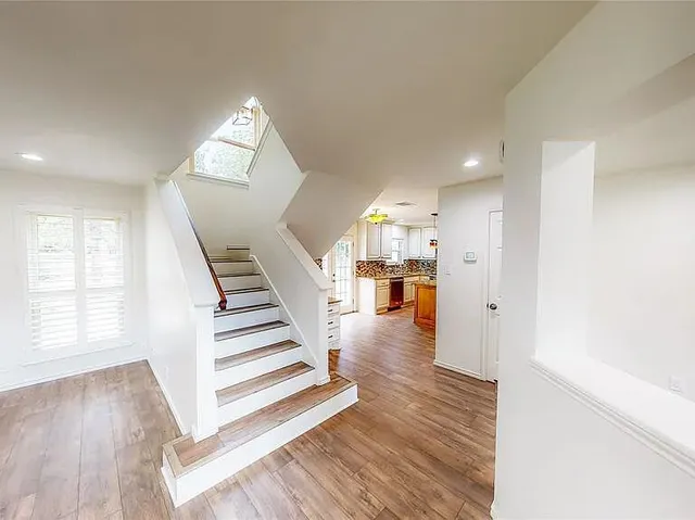 a view of entryway and hall with wooden floor