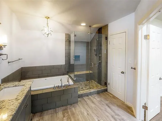 a bathroom with a tub sink and shower