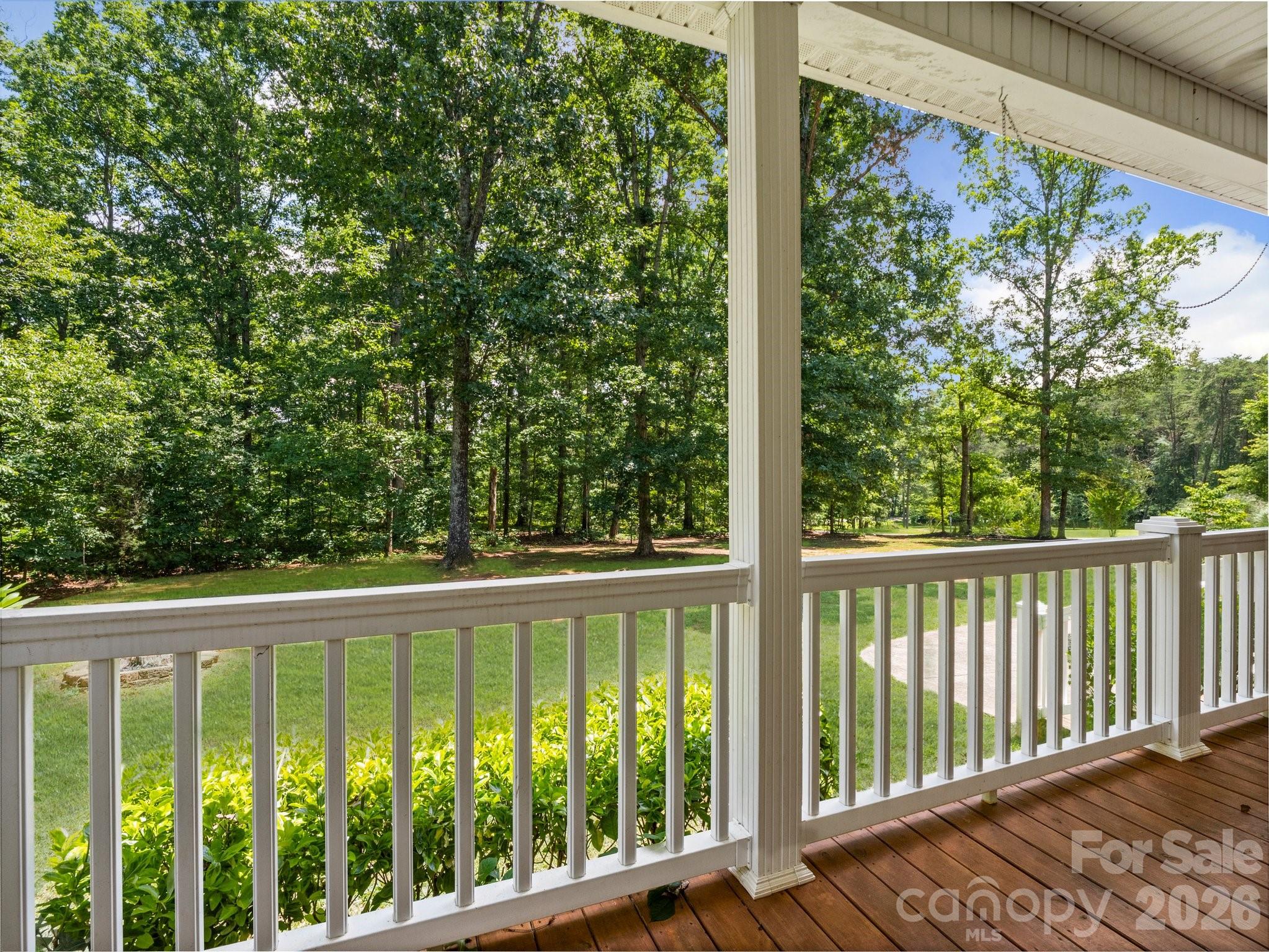 217 Blossom Hill Road Lincolnton, NC 28092 - Photo 11 of 44 a view of a wooden balcony with a tree