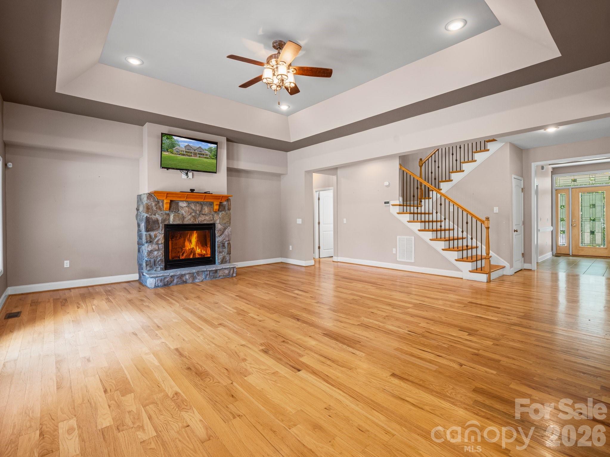 217 Blossom Hill Road Lincolnton, NC 28092 - Photo 14 of 44 a view of an empty room with stairs and a fireplace