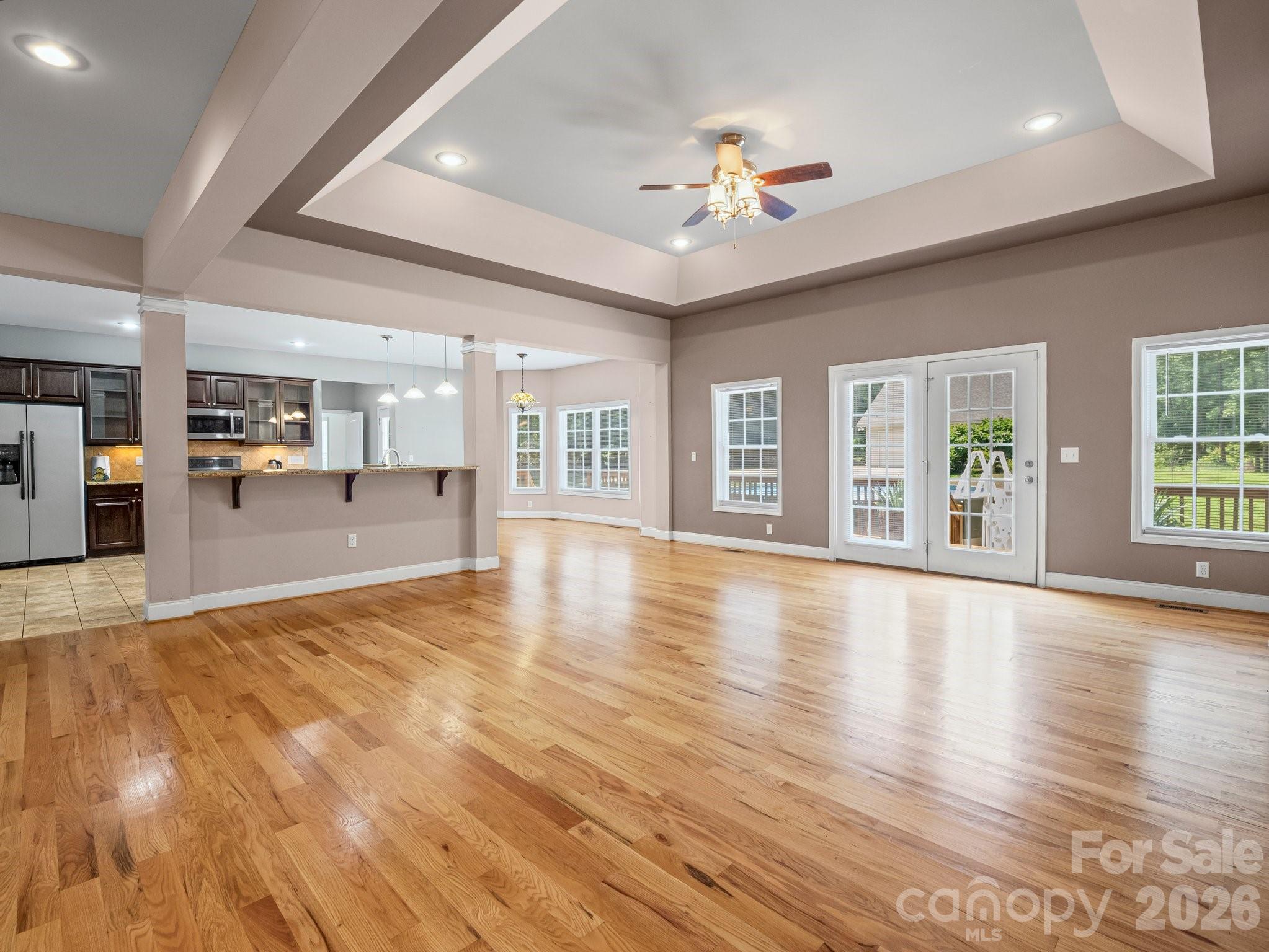 217 Blossom Hill Road Lincolnton, NC 28092 - Photo 16 of 44 a view of an empty room with wooden floor and a kitchen
