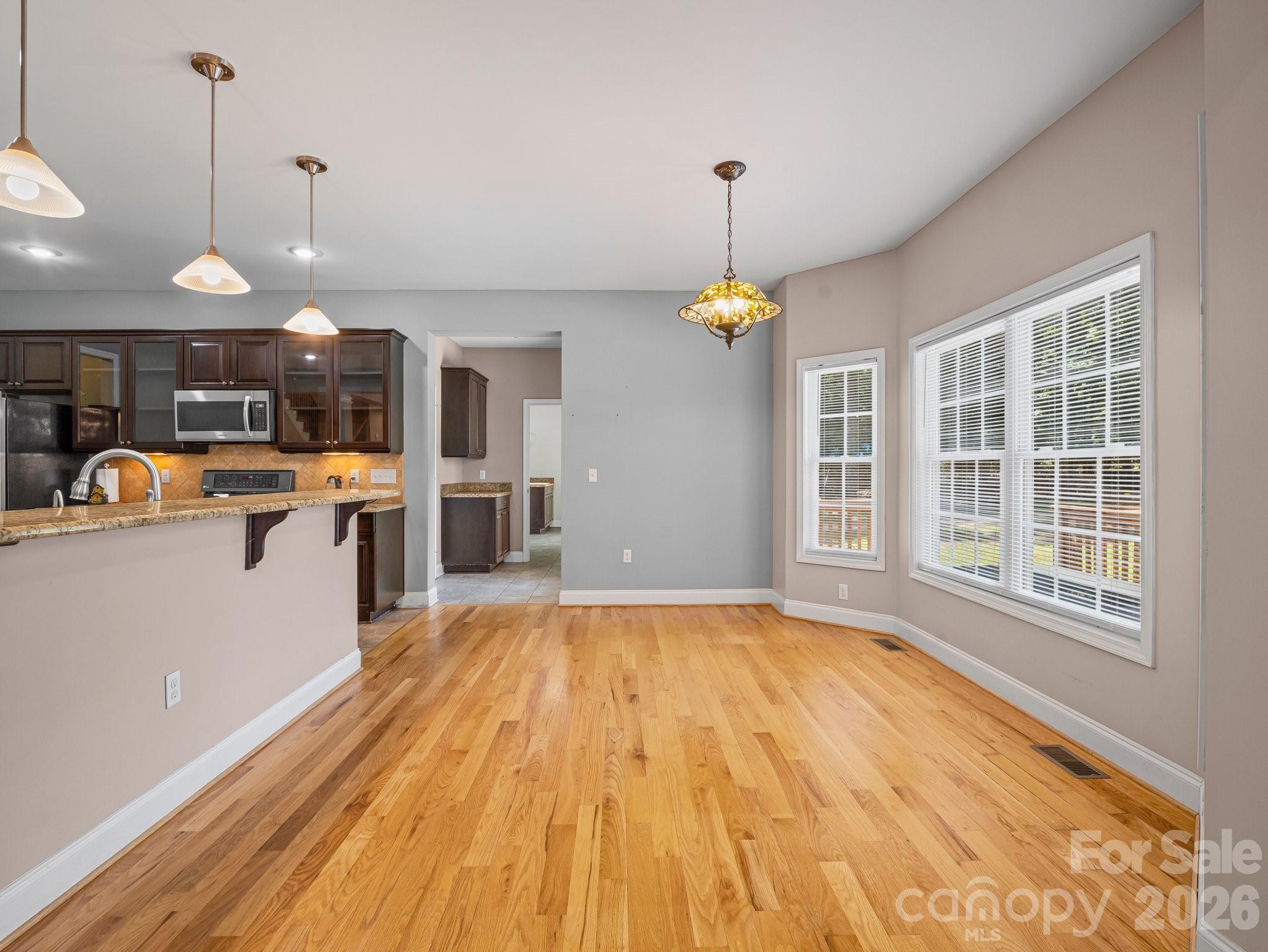 217 Blossom Hill Road Lincolnton, NC 28092 - Photo 20 of 44 a view of a kitchen with a sink wooden floor and windows