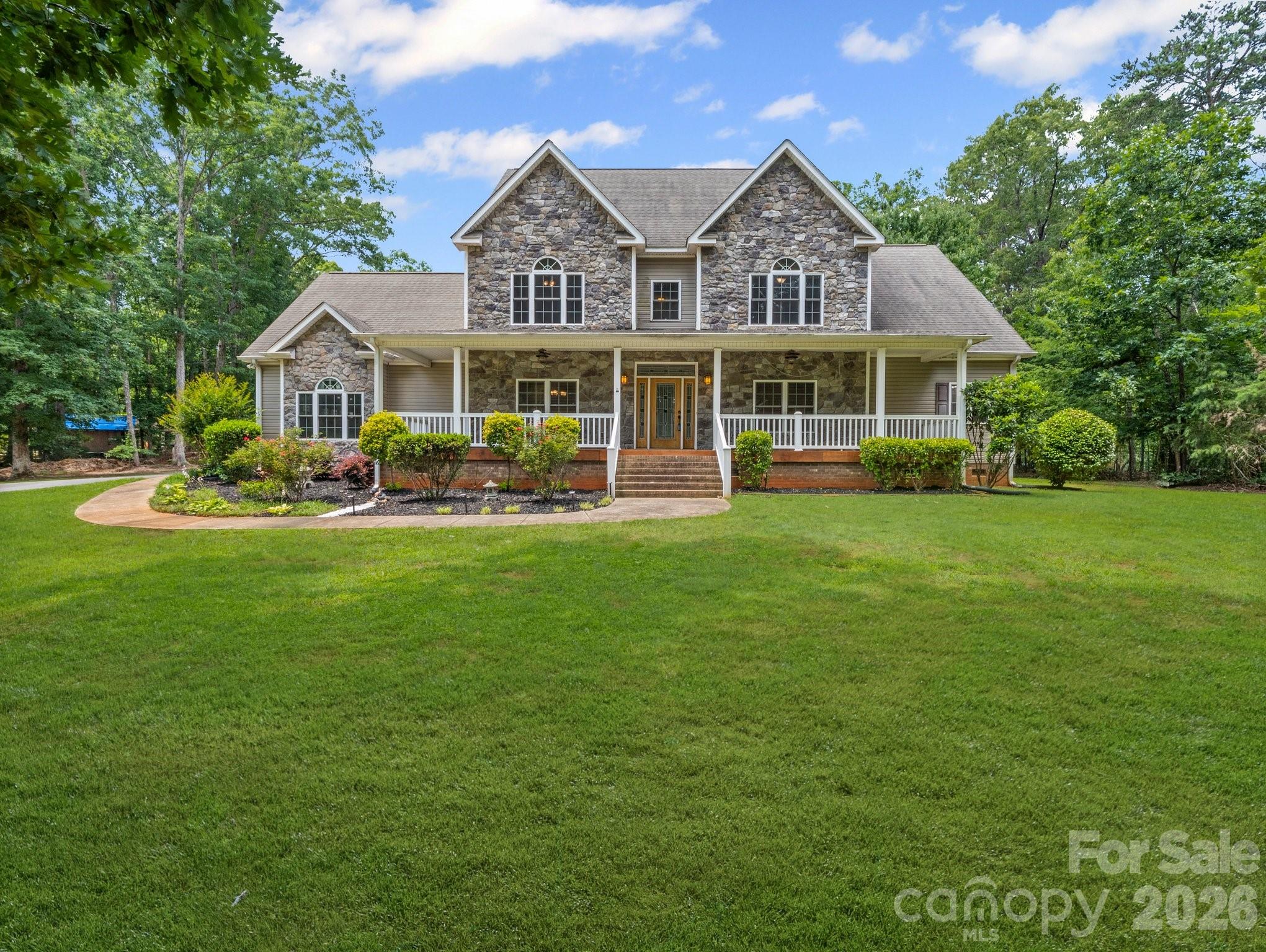 217 Blossom Hill Road Lincolnton, NC 28092 - Photo 2 of 44 a front view of a house with a garden