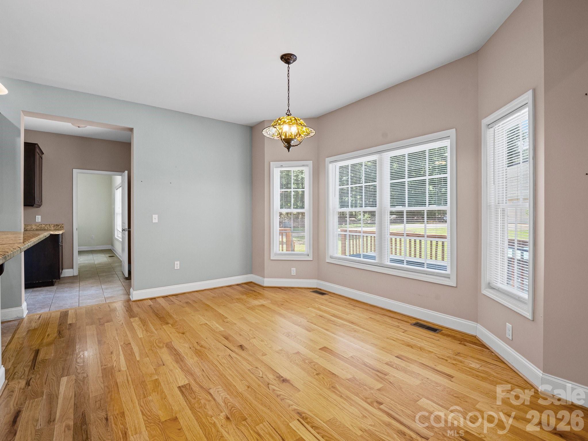 217 Blossom Hill Road Lincolnton, NC 28092 - Photo 21 of 44 a view of an empty room with a window and wooden floor