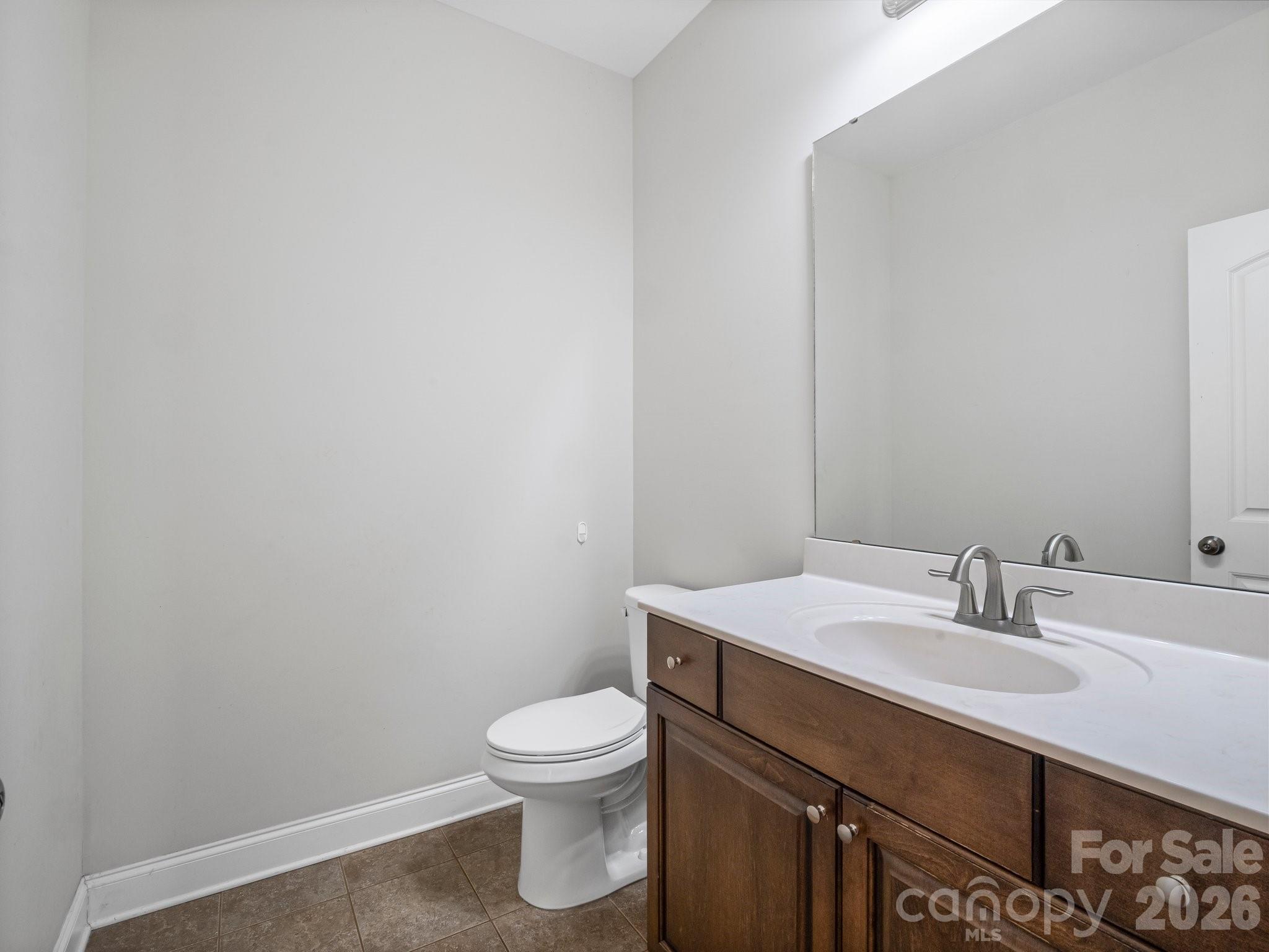 217 Blossom Hill Road Lincolnton, NC 28092 - Photo 27 of 44 a bathroom with a sink toilet and vanity