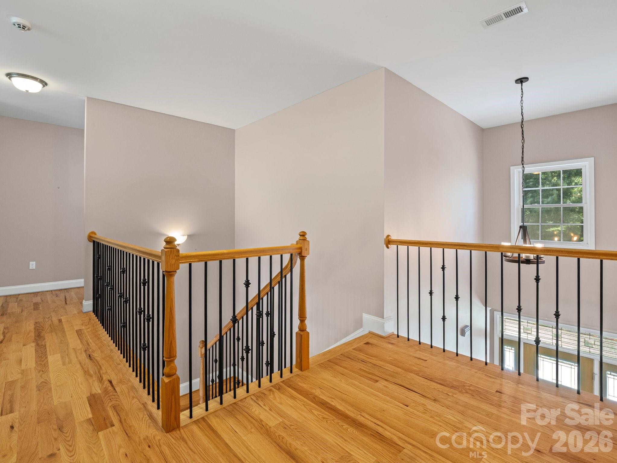 217 Blossom Hill Road Lincolnton, NC 28092 - Photo 32 of 44 a view of a hallway with wooden floor and stairs