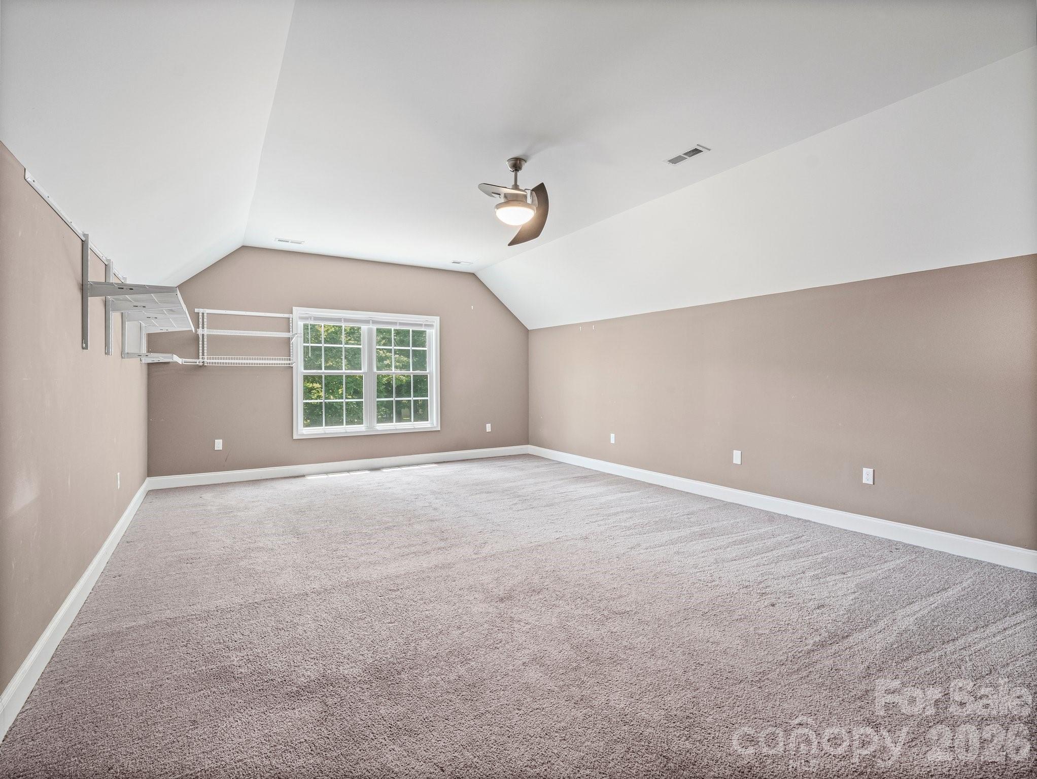 217 Blossom Hill Road Lincolnton, NC 28092 - Photo 35 of 44 an empty room with windows and fan