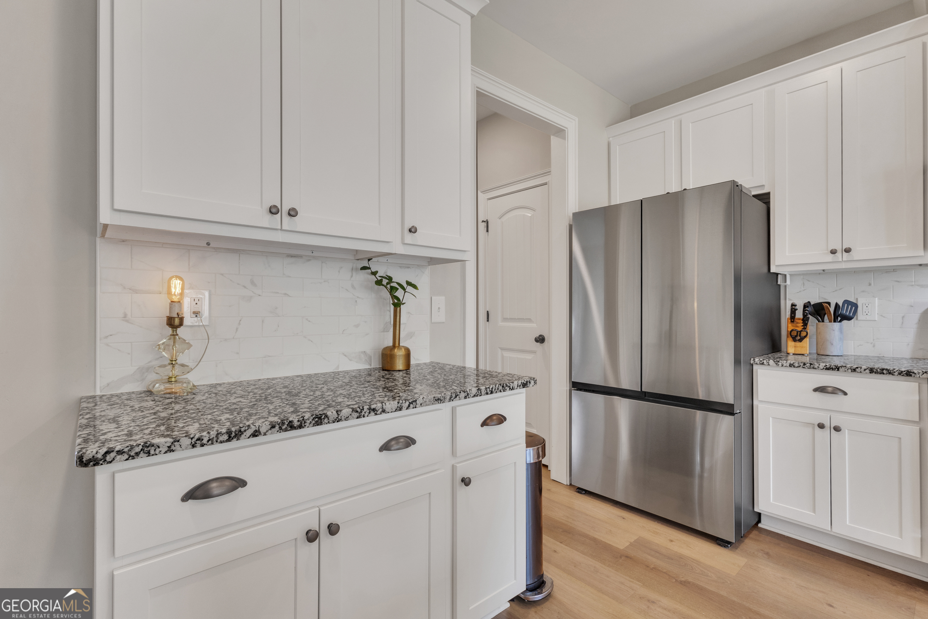 50 Cushing Street Senoia, GA 30276 - Photo 14 of 72 a kitchen with stainless steel appliances granite countertop a refrigerator sink and cabinets