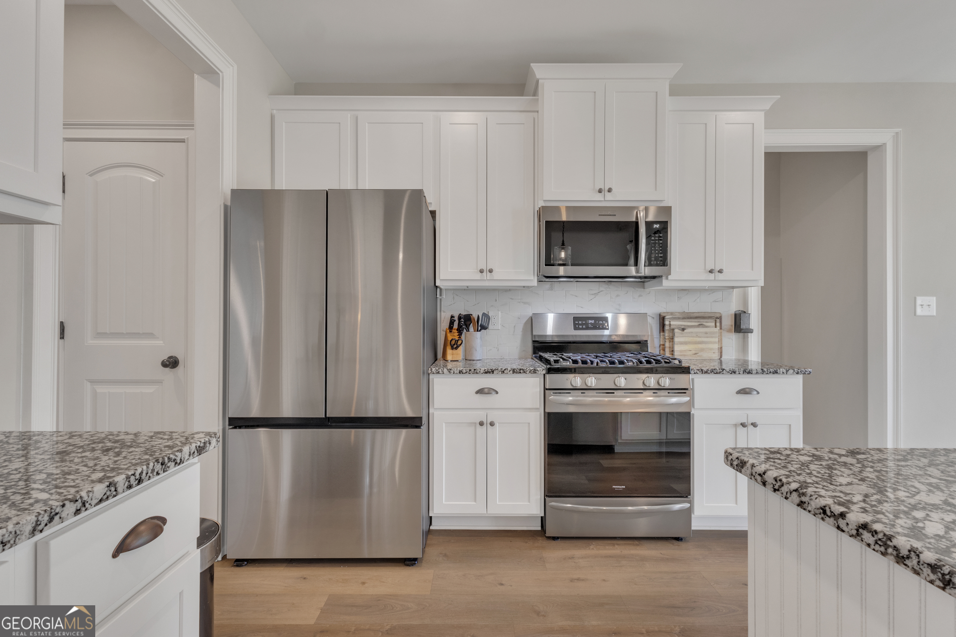 50 Cushing Street Senoia, GA 30276 - Photo 15 of 72 a kitchen with granite countertop a refrigerator stove and microwave
