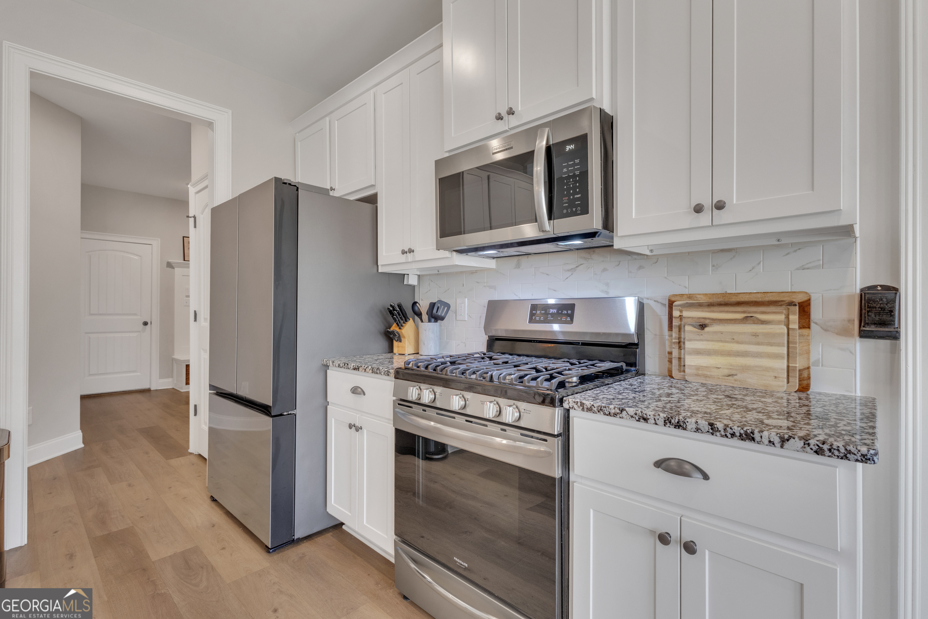 50 Cushing Street Senoia, GA 30276 - Photo 17 of 72 a kitchen with stainless steel appliances wooden cabinets and a stove top oven