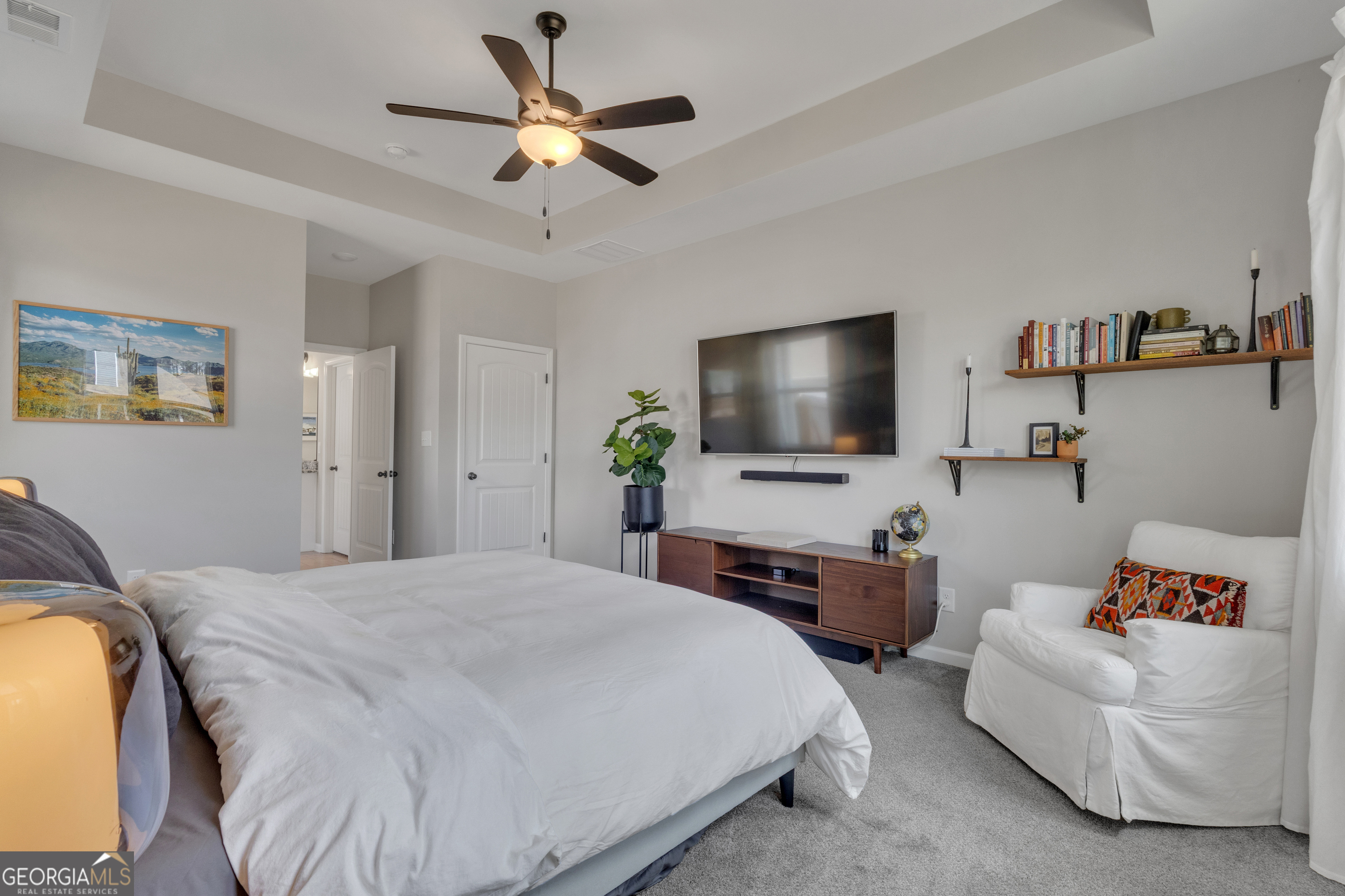 50 Cushing Street Senoia, GA 30276 - Photo 24 of 72 a spacious bedroom with a bed and a flat screen tv