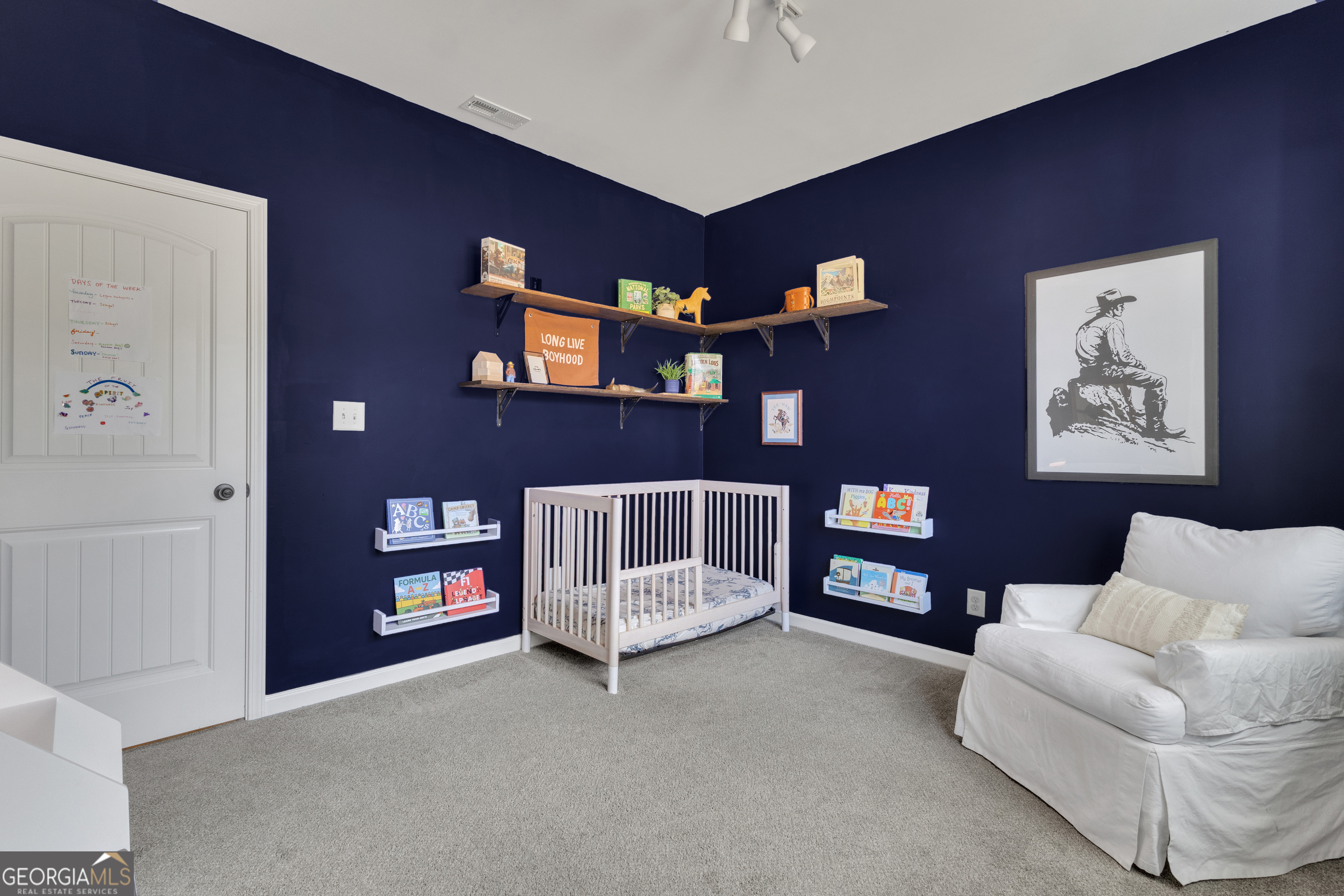 50 Cushing Street Senoia, GA 30276 - Photo 33 of 72 a living room with furniture and a chandelier
