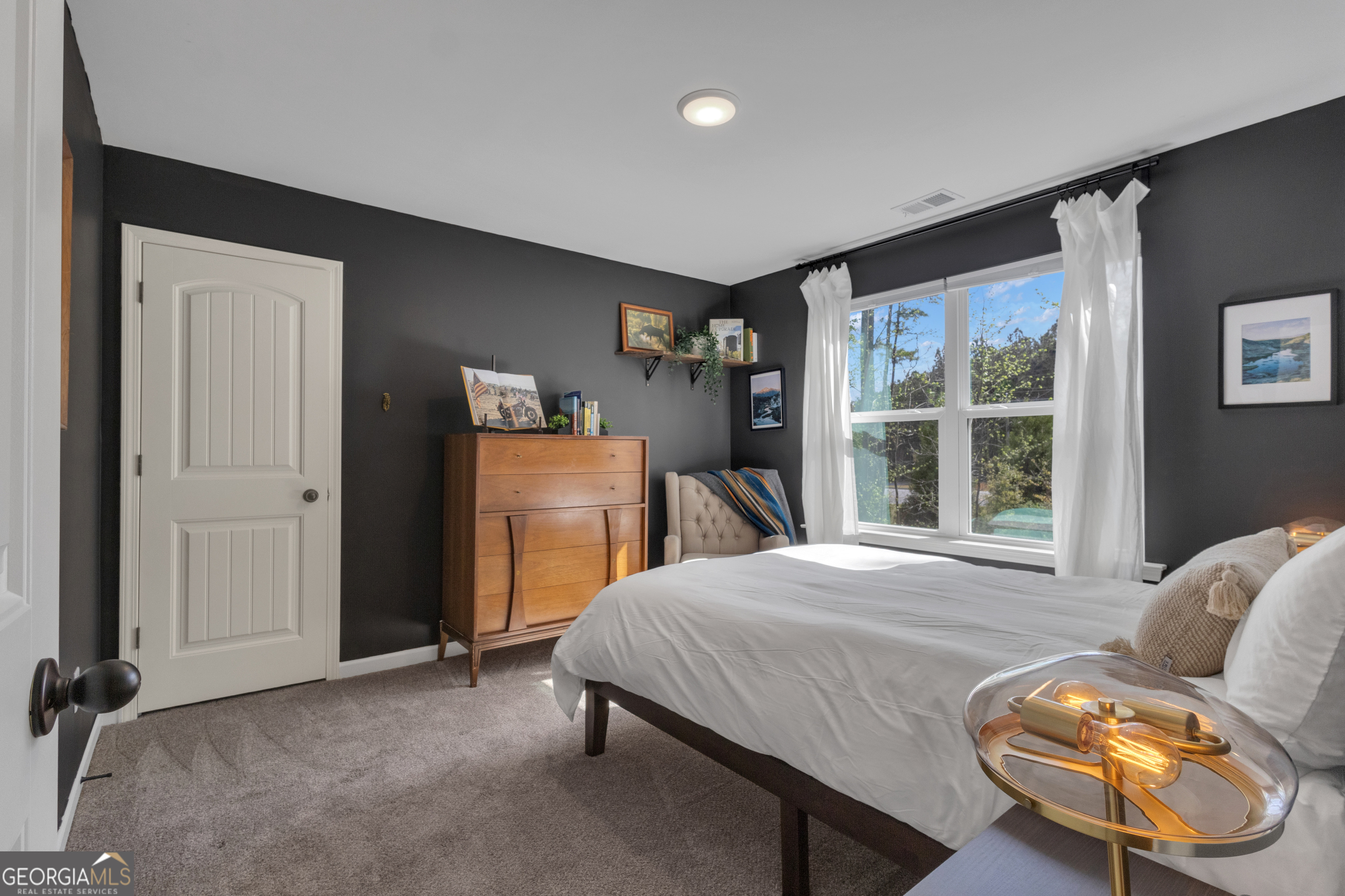 50 Cushing Street Senoia, GA 30276 - Photo 46 of 72 a bedroom with a bed and wooden floor