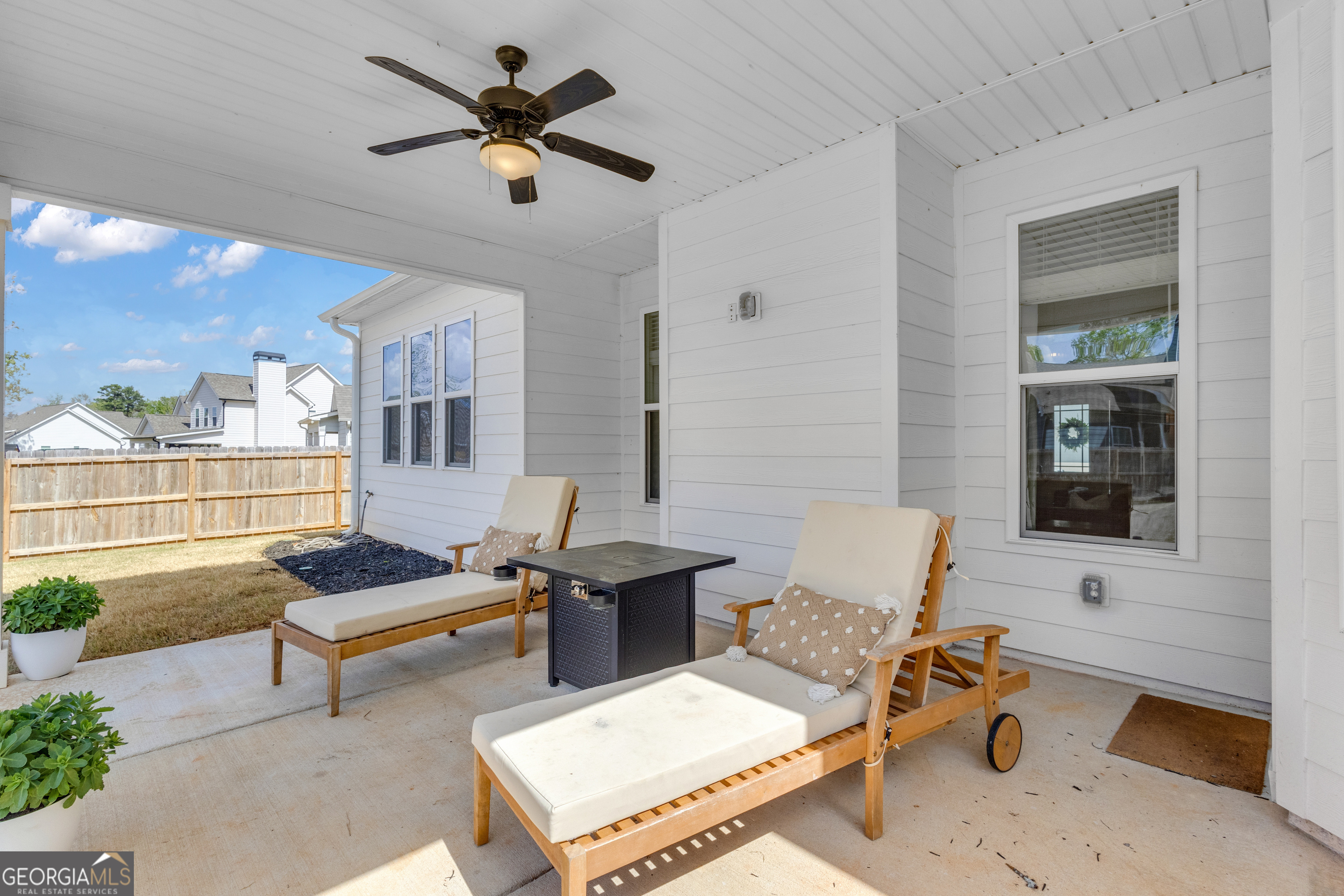 50 Cushing Street Senoia, GA 30276 - Photo 51 of 72 a living room with furniture a rug and a chandelier